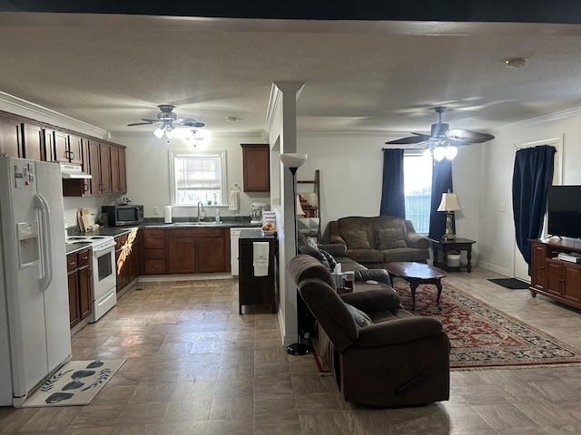 kitchen with sink, crown molding, white appliances, ceiling fan, and a textured ceiling