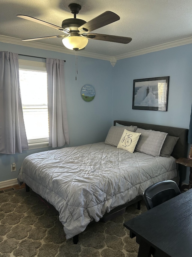 bedroom with ceiling fan, ornamental molding, and a textured ceiling