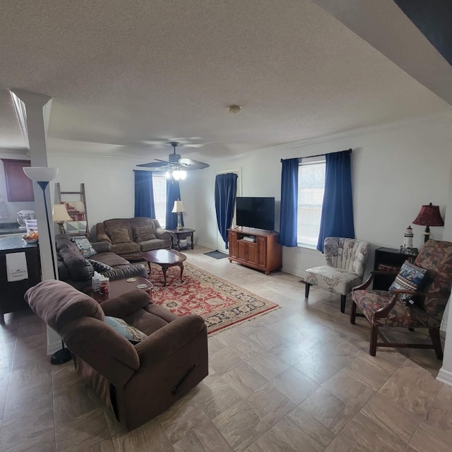 living room with ceiling fan and a textured ceiling