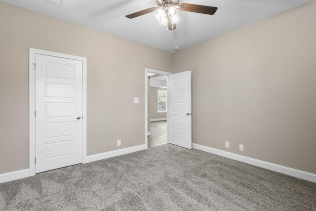 unfurnished bedroom with ceiling fan and carpet