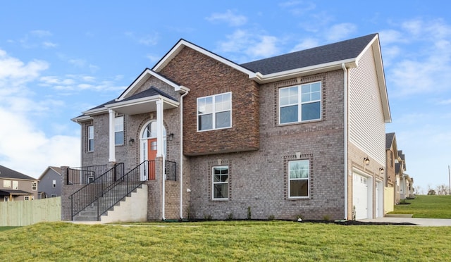 view of front of property with a garage and a front lawn