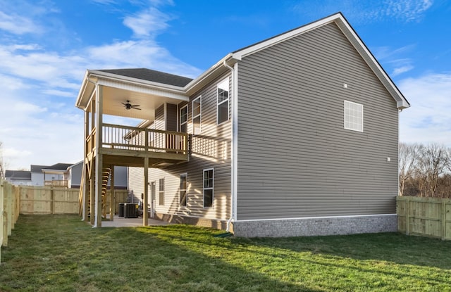 view of side of home featuring a patio, ceiling fan, and a lawn