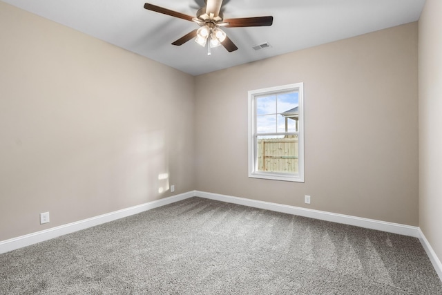 carpeted spare room featuring ceiling fan