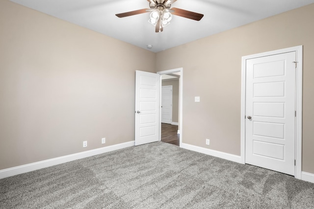 unfurnished bedroom with ceiling fan and carpet