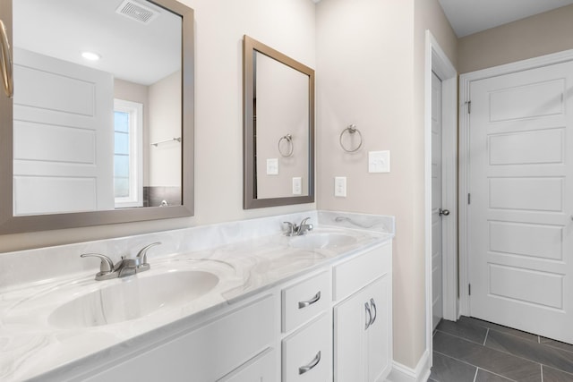 bathroom with tile patterned flooring and vanity