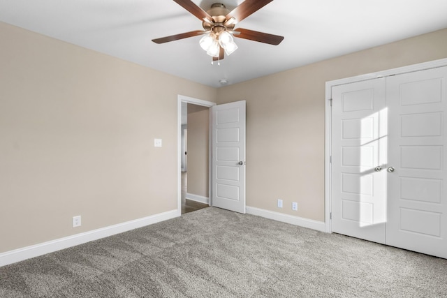 carpeted spare room with ceiling fan