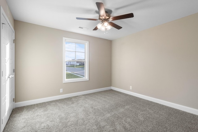 carpeted empty room featuring ceiling fan