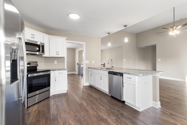 kitchen featuring light stone countertops, white cabinetry, appliances with stainless steel finishes, and sink