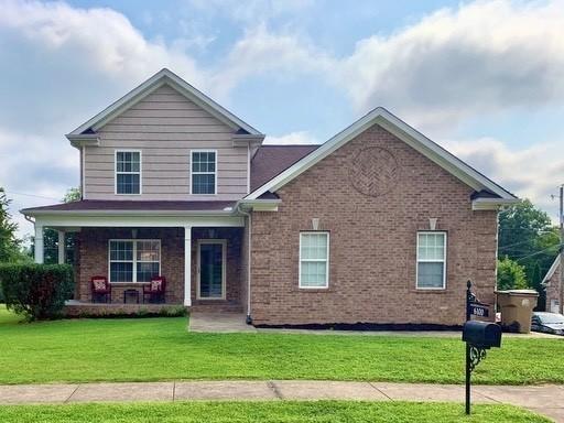 view of front of property with a front yard and a porch