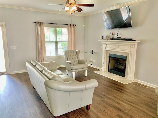 living room featuring ceiling fan, ornamental molding, and dark hardwood / wood-style flooring