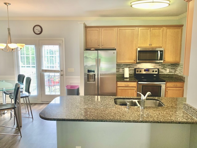 kitchen with crown molding, sink, decorative backsplash, and appliances with stainless steel finishes