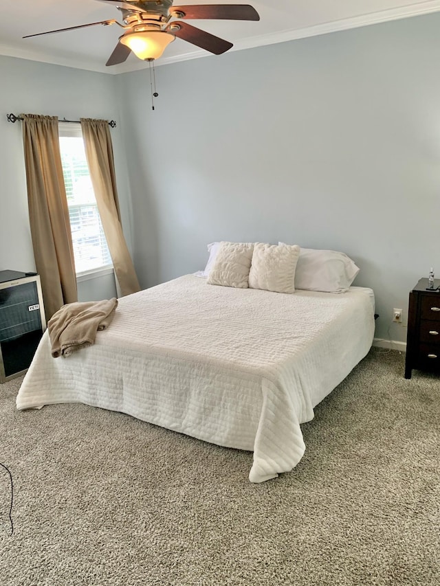 carpeted bedroom featuring ceiling fan and ornamental molding