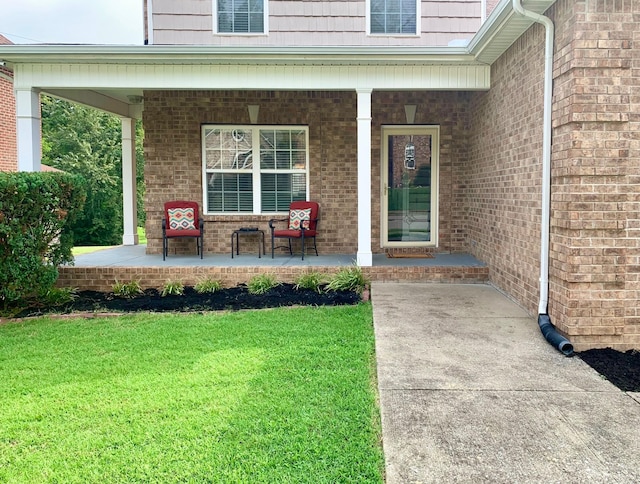 property entrance with a yard and a porch