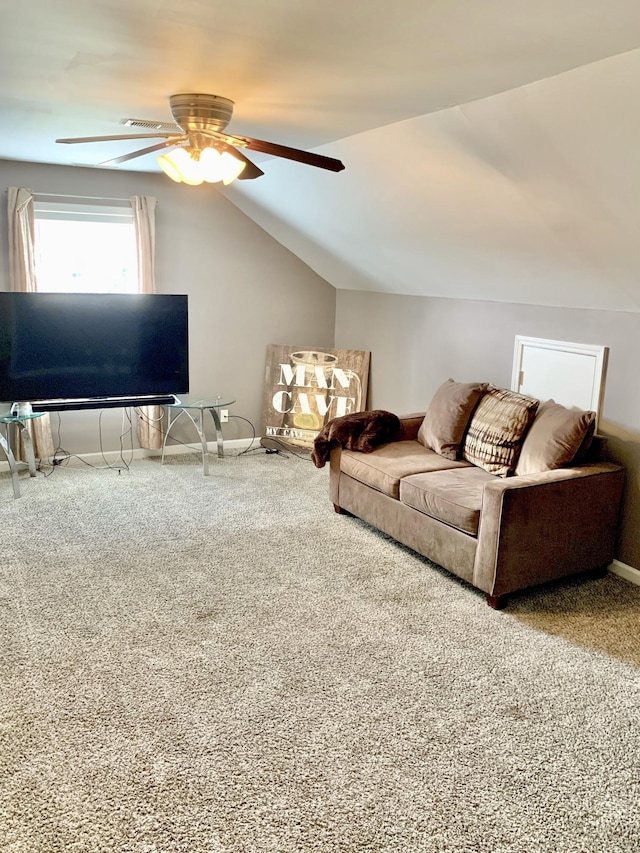 living room with ceiling fan, carpet floors, and vaulted ceiling