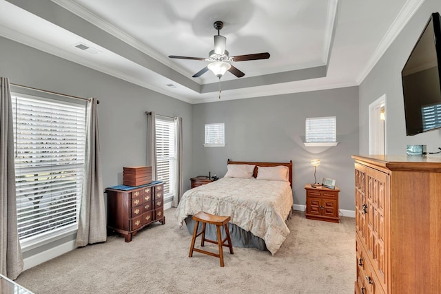 carpeted bedroom featuring crown molding, a raised ceiling, and ceiling fan