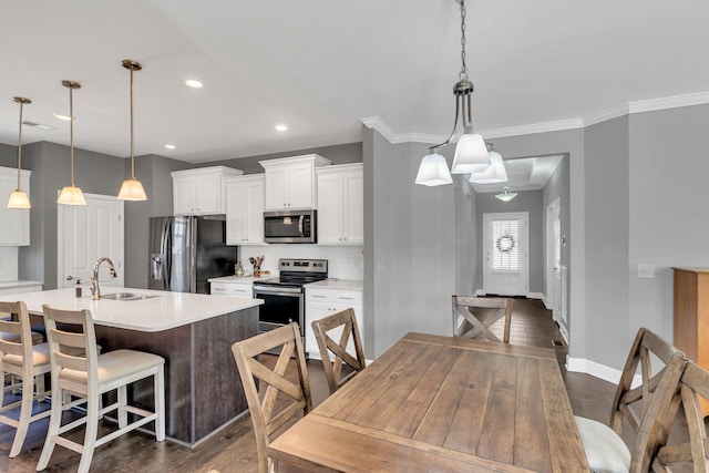 dining room with dark hardwood / wood-style flooring, sink, and crown molding