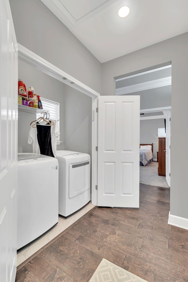 laundry area featuring washer and dryer and dark wood-type flooring