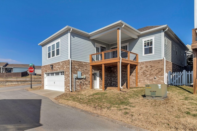 view of front of home featuring a garage, a balcony, and a front yard