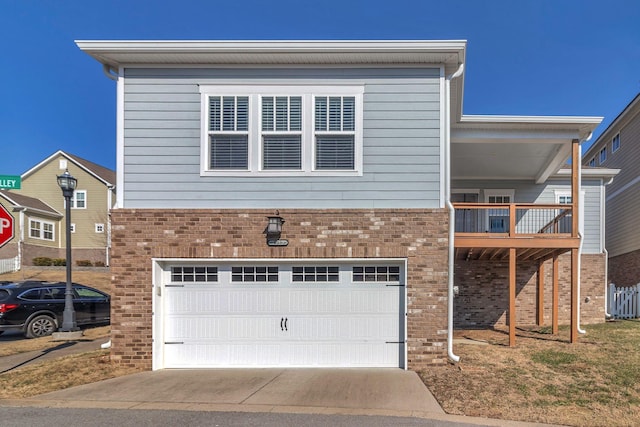 view of front of property featuring a garage and a balcony