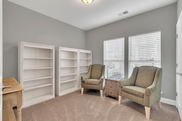 living area featuring light colored carpet