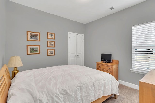 carpeted bedroom featuring a closet