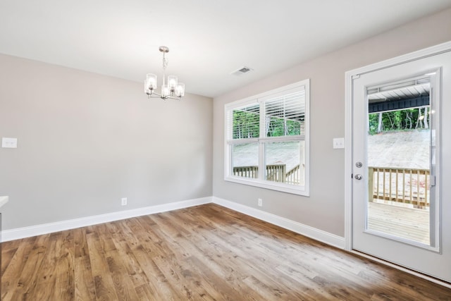 interior space featuring a chandelier and light hardwood / wood-style flooring