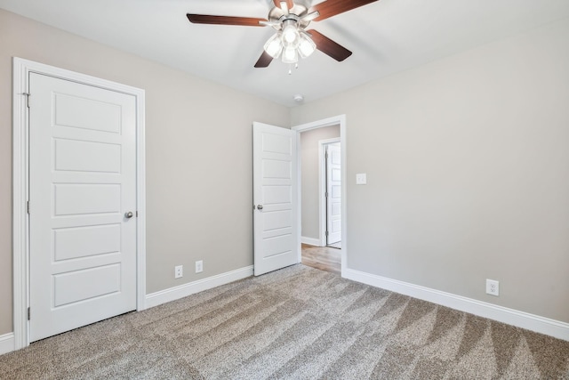 unfurnished bedroom with ceiling fan and carpet