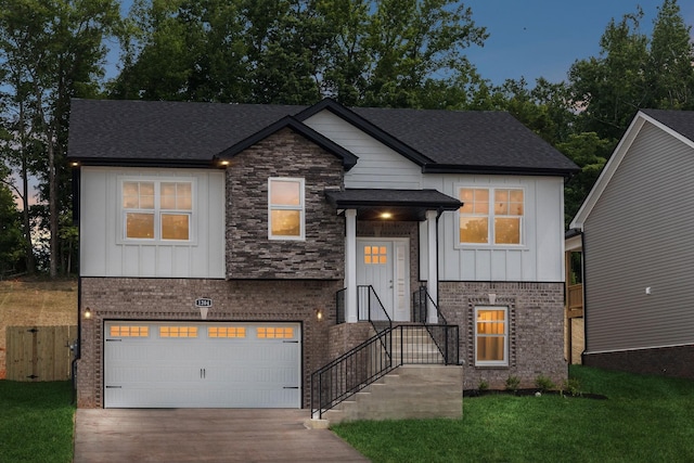 view of front facade with brick siding, a shingled roof, an attached garage, board and batten siding, and driveway