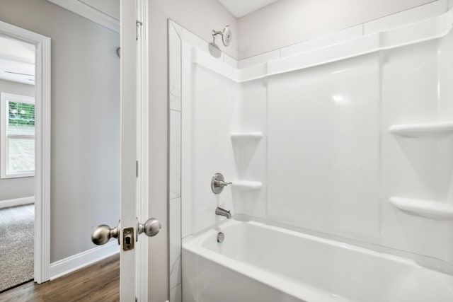 bathroom with hardwood / wood-style flooring and shower / bathing tub combination