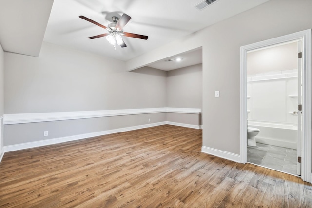 basement with ceiling fan and light wood-type flooring