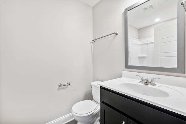 bathroom with vanity, toilet, and walk in shower