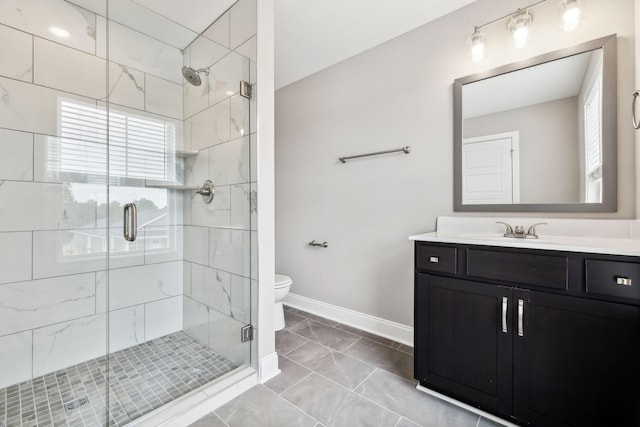 bathroom featuring vanity, toilet, and an enclosed shower