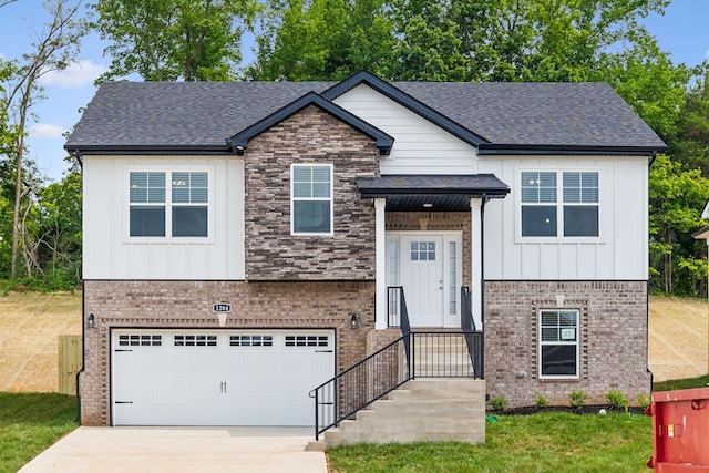 view of front of home with a garage, driveway, brick siding, and board and batten siding