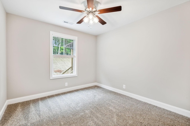 empty room featuring carpet floors and ceiling fan