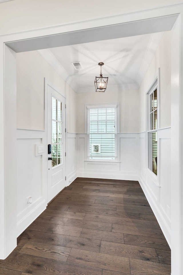 unfurnished dining area featuring dark hardwood / wood-style flooring and a chandelier