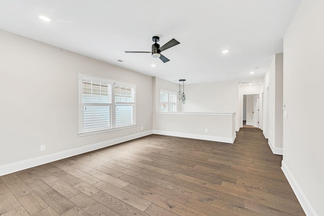 unfurnished room featuring dark wood-type flooring and ceiling fan