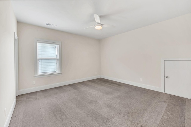 carpeted spare room with ceiling fan