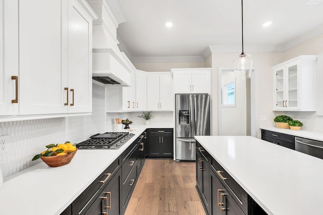 kitchen with white cabinetry, appliances with stainless steel finishes, and pendant lighting