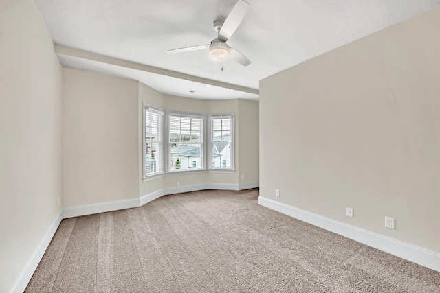 empty room featuring ceiling fan and carpet floors