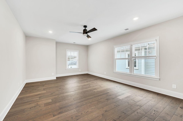 empty room with dark wood-type flooring and ceiling fan