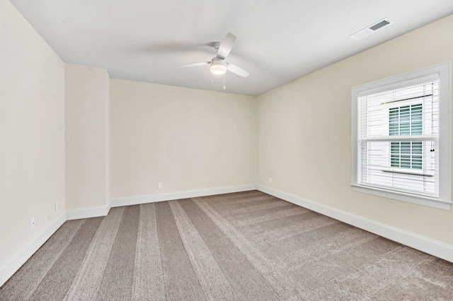 unfurnished room with ceiling fan and carpet flooring