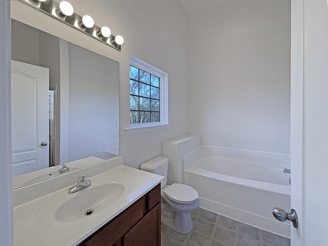 bathroom with vanity, toilet, and a bathing tub