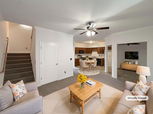 carpeted living room featuring ornamental molding and ceiling fan