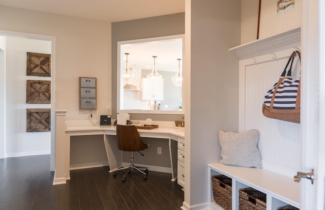 office featuring dark wood-type flooring and built in desk