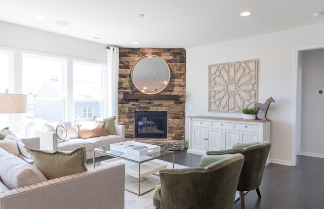 living room featuring dark wood-type flooring and a fireplace