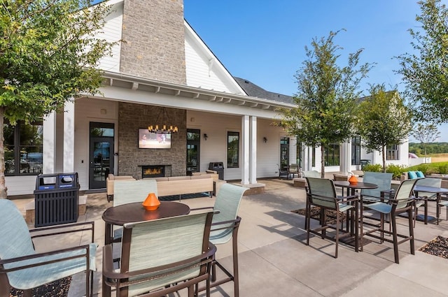 view of patio with an outdoor stone fireplace