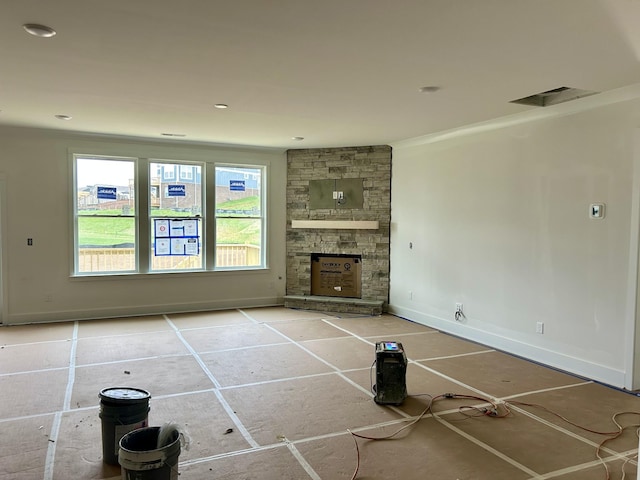 unfurnished living room with ornamental molding and a fireplace