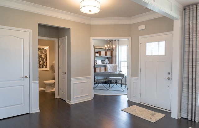 entrance foyer featuring ornamental molding and dark hardwood / wood-style floors