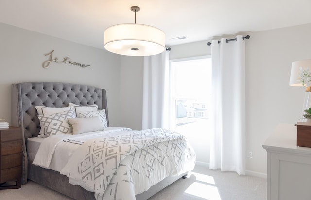 bedroom featuring light carpet