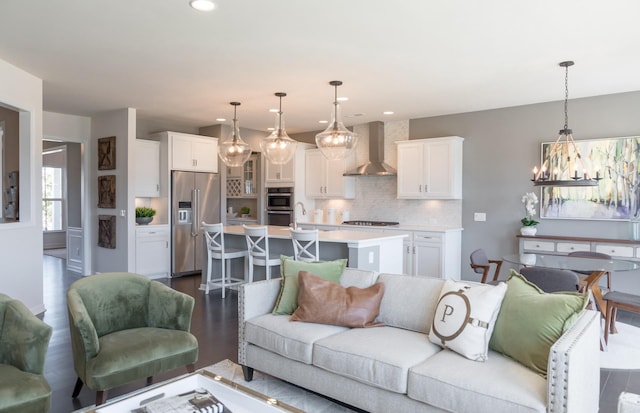 living room with dark hardwood / wood-style flooring, sink, and a notable chandelier